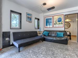 a living room with a black couch in a room at Holiday Home Villa Dragica by Interhome in Labin
