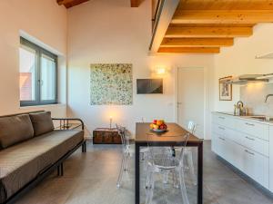 a living room with a couch and a table at Apartment Camping Turisport-1 by Interhome in Dervio