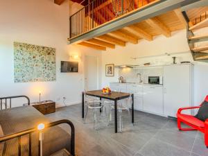 a kitchen and dining room with a table and chairs at Apartment Camping Turisport-1 by Interhome in Dervio