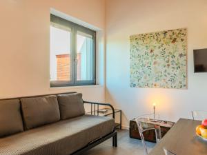 a living room with a couch and a window at Apartment Camping Turisport-1 by Interhome in Dervio +20 photos