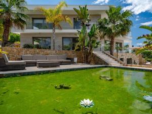 a house with a pond in front of a building at Villa Villa Eos by Interhome in Jávea