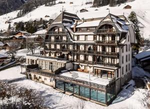 an aerial view of a building in the snow at Luxury Apartment, Panoramic Mountain Views, 5 Star Spa Facilities - 3 Bedroom in Chateau-d'Oex