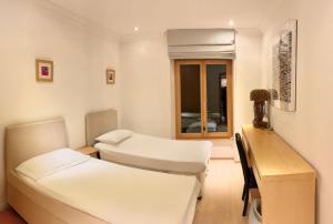 a hospital room with two beds and a desk at Luxury Apartment, Panoramic Mountain Views, 5 Star Spa Facilities - 3 Bedroom in Chateau-d'Oex +23 photos