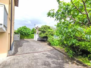 a walkway outside of a house with trees at Apartment Calicantus by Interhome in Dro