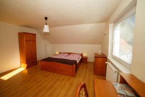 A bed or beds in a room at Apartmánový Dom River