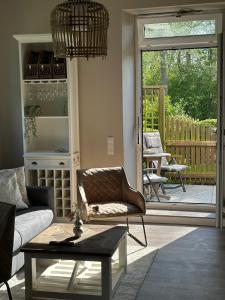 a living room with a couch and a table at Ferienwohnung Alte Schule Vitzdorf im Hamptons-Stil mit großer Terrasse! in Fehmarn