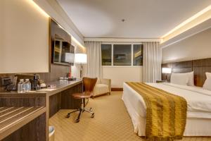 a hotel room with a bed and a desk at K Hotel in Goiânia +80 photos