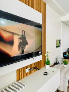 a large flat screen tv on a wall in a living room at MyHome Condo with Balcony in Iloilo City