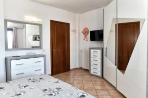 a bathroom with a sink and a mirror at Perla Apartment con vista mare in Olbia +23 photos