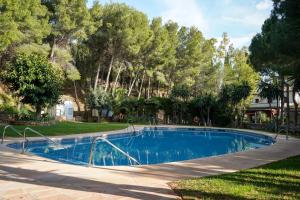 a swimming pool in a yard with trees at Casa El Cholo, Mijas Hideaway in Mijas