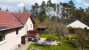 a view of the backyard of a house with a picnic table at Killiechangie House in Newtonmore