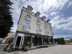 a large building with windows and chairs at Mont Blanc Hotel in Peshkopi