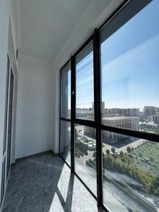 an empty room with a large window with a view at Посуточно 3 комн в ЖК Аль Фараби in Shymkent