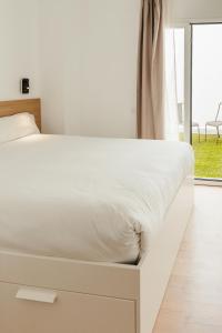 Łóżko lub łóżka w pokoju w obiekcie ASTUTO 21 Suites - Adults Only
