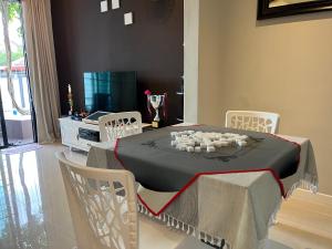 a dining room with a table with candles on it at Fairy Retreat Private Pool Cottage IPOH, BBQ, KTV, 10-12 pax in Ipoh