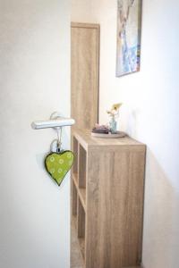 a wooden stand with a heart hanging on a wall at wolke 7, Bergblick Apartment, Kingsizebett & Schlafcouch, Balkon & Garten in Kiefersfelden +19 photos