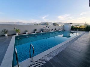 a swimming pool on the roof of a house at Eminence The Corbett in Jhirna