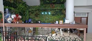 a green wall in a room with a table at Hotel O Kebayoran in Jakarta