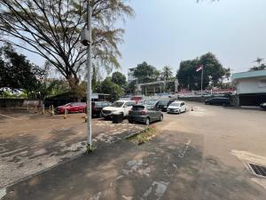 a parking lot with a bunch of cars parked at Hotel O Kebayoran in Jakarta