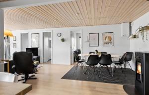 a living room with a table and black chairs at Holiday Home Egernsund With A Fireplace 316 in Egernsund