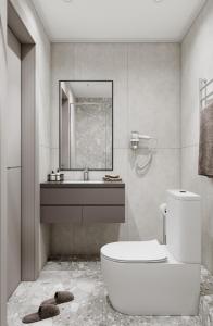 a bathroom with a toilet and a sink and a mirror at Достык Люкс in Kostanay