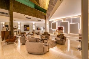a lobby with couches and chairs in a building at K Hotel in Goiânia