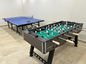 two ping pong tables sitting next to each other at Lux Villa Nymphes Dioni, 30m from beach with Pool, BBQ and Play Area in Stavromenos +31 photos