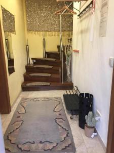 a hallway with stairs and a rug on the floor at Ferienhaus Schöndorf in Tholey