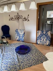 a table with a blue plate on top of it at Ferienhaus Schöndorf in Tholey +32 photos