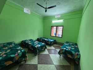 Postel nebo postele na pokoji v ubytování Manoranjan villa