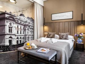 a hotel room with two beds and a picture of a building at Hotel Logos Kraków in Krakow