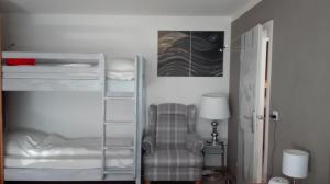a room with a chair and a bunk bed at Sonnenbichl Wh 201 in Oberstdorf