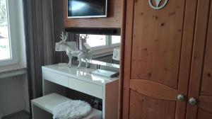 a room with a table with a statue of a deer on it at Sonnenbichl Wh 201 in Oberstdorf
