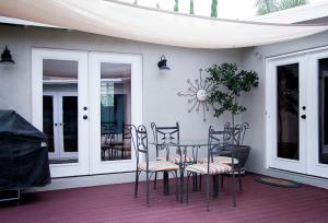 a table and chairs sitting on a porch with a table at Getaway Beach Bungalow - Kid and Pet Friendly in Carlsbad