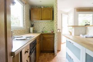 a kitchen with wooden cabinets and a counter top at Ferienhaus Für 2 Personen Ca 35 M Sup2 In Seegebiet Mansfelder Land Seeburg, Sachsen Anhalt Mansfelder Land in Seeburg