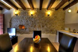 a wooden table with a bowl of fruit on it at Stone House Kotli in Kotli +31 photos