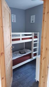 a room with three bunk beds in a room at Butje in Zinnowitz