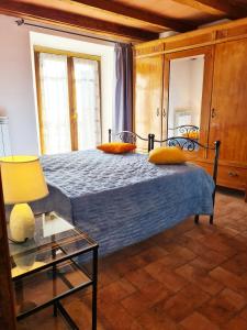 a bedroom with a bed and a glass table at La Corte in Pratovecchio +14 photos