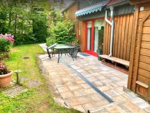 a patio with a table and a bench next to a house at Sequoia in Goslar