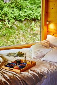 a tray of food sitting on top of a bed at Postcard Cabins Machimoodus, Outdoor Collection by Marriott Bonvoy in Moodus