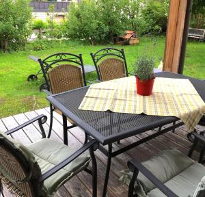 a table with chairs and a potted plant on a patio at Ferienhaus Haus Barbara In Aschau Im Zillertal in Aschau
