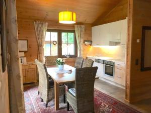 a kitchen with a table and chairs in a cabin at Ferienhaus Haus Barbara In Aschau Im Zillertal in Aschau