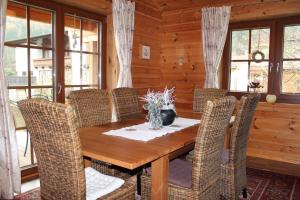 a dining room with a wooden table and chairs at Ferienhaus Haus Barbara In Aschau Im Zillertal in Aschau