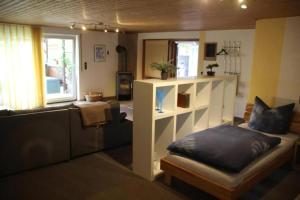 a living room with a couch and a shelf at Ferienwohnung Loni In Viereth in Viereth