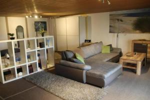 a living room with a couch and a table at Ferienwohnung Loni In Viereth in Viereth