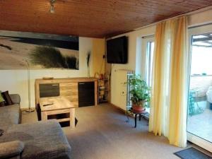 a living room with a couch and a table at Ferienwohnung Loni In Viereth in Viereth +19 photos
