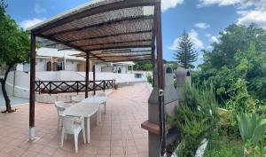 a pavilion with tables and chairs on a patio at Villa Antonio in Forio d'Ischia