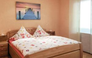 a bedroom with a bed with a painting on the wall at Ferienbungalow Anne in Wadern