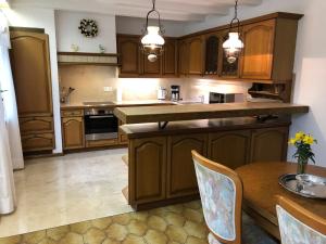 a kitchen with wooden cabinets and a wooden table at Ferienbungalow Anne in Wadern