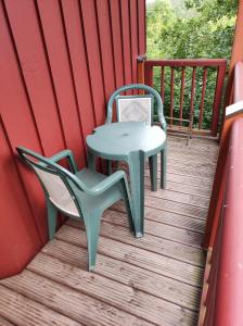 a table and chairs sitting on a deck at Dream Apartment in Rötz